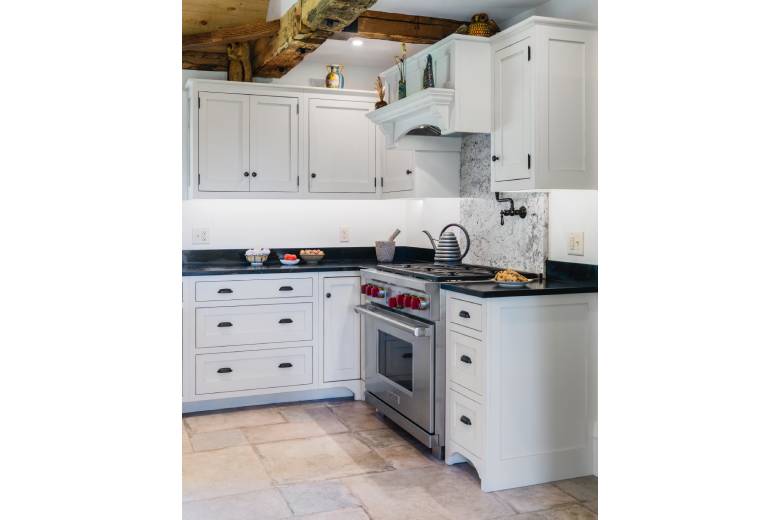 Gas Range Stove with White Cabinets and Granite Features