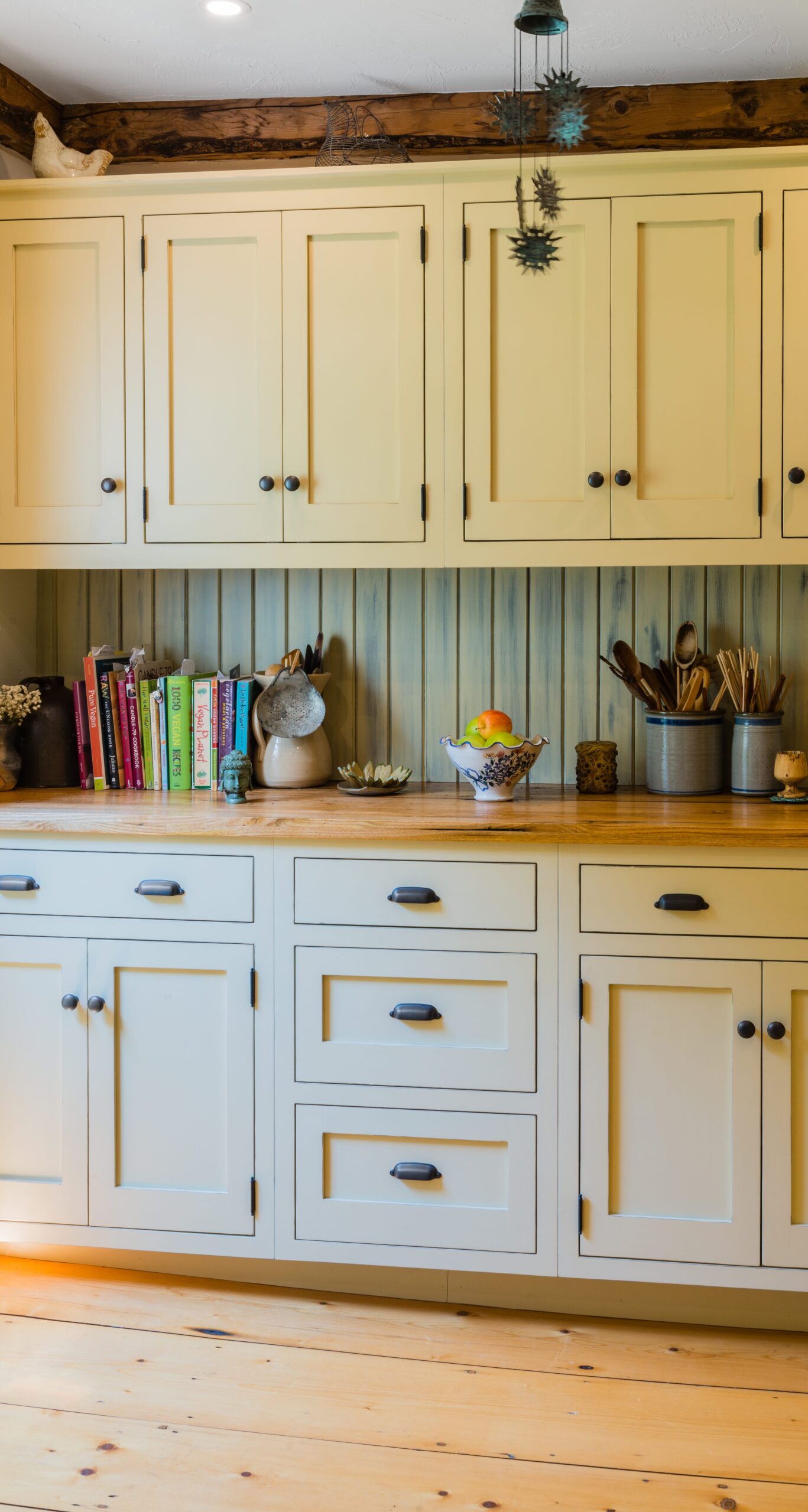 timber frame kitchen with white cabinets and wooden floors