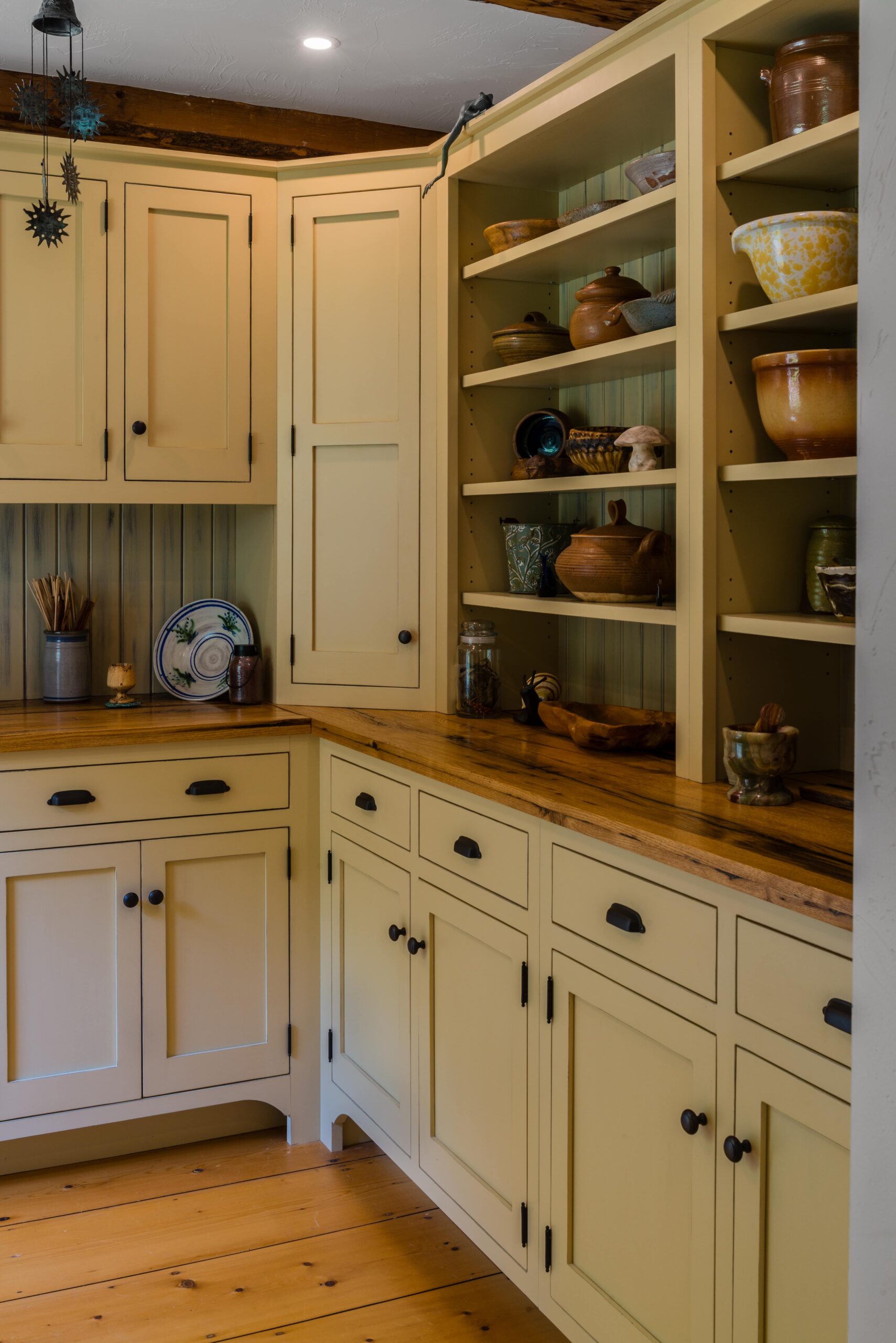 timber frame kitchen with wooden floors and white cabinets with open shelving