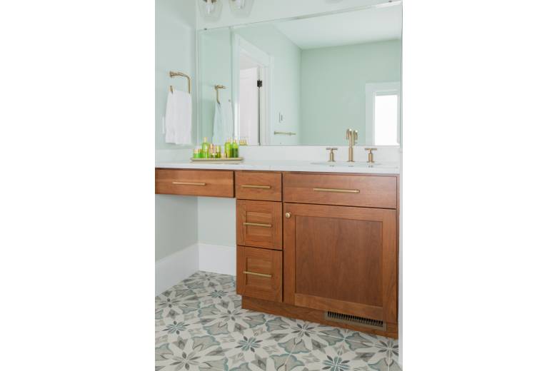 Bathroom Sink with Wooden Brown Cabinets, White Counters and Gold Accents