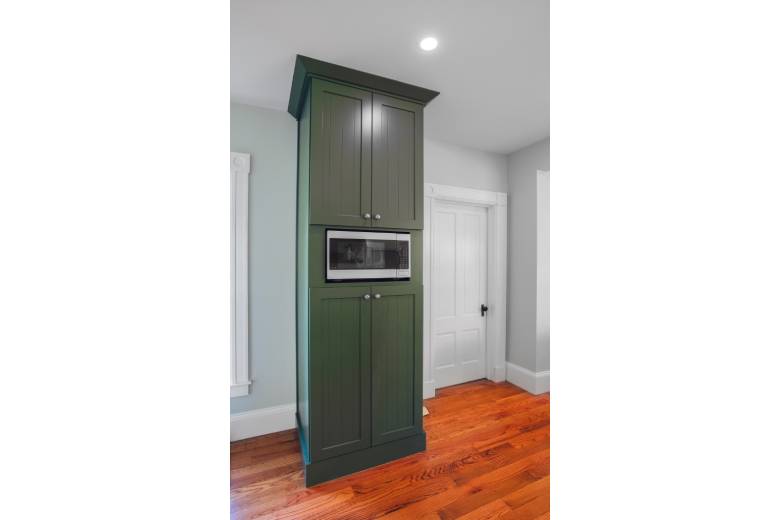 Green built in cabinets with microwave