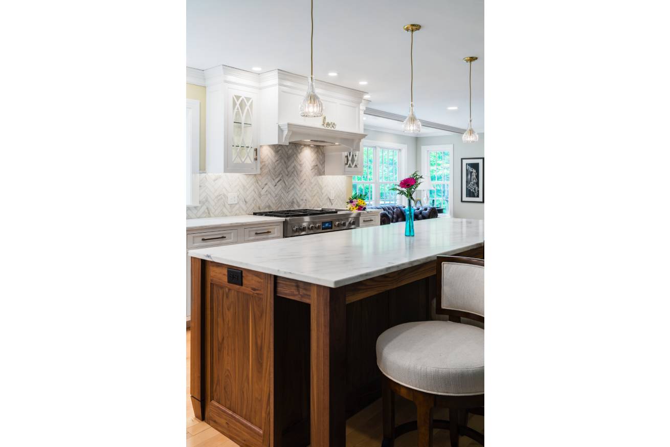 Granite Kitchen Island with White Countertop and a barstool