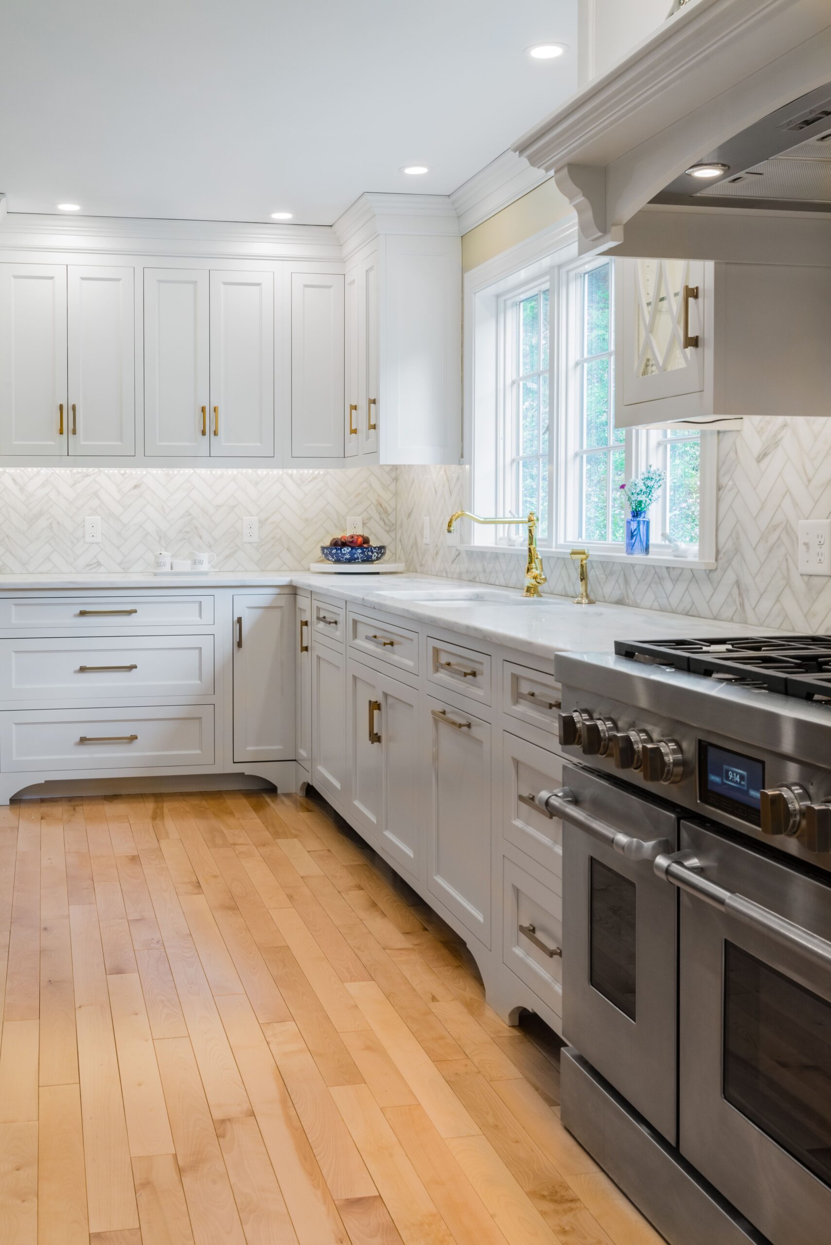 White kitchen renovation with gold brass fixtures