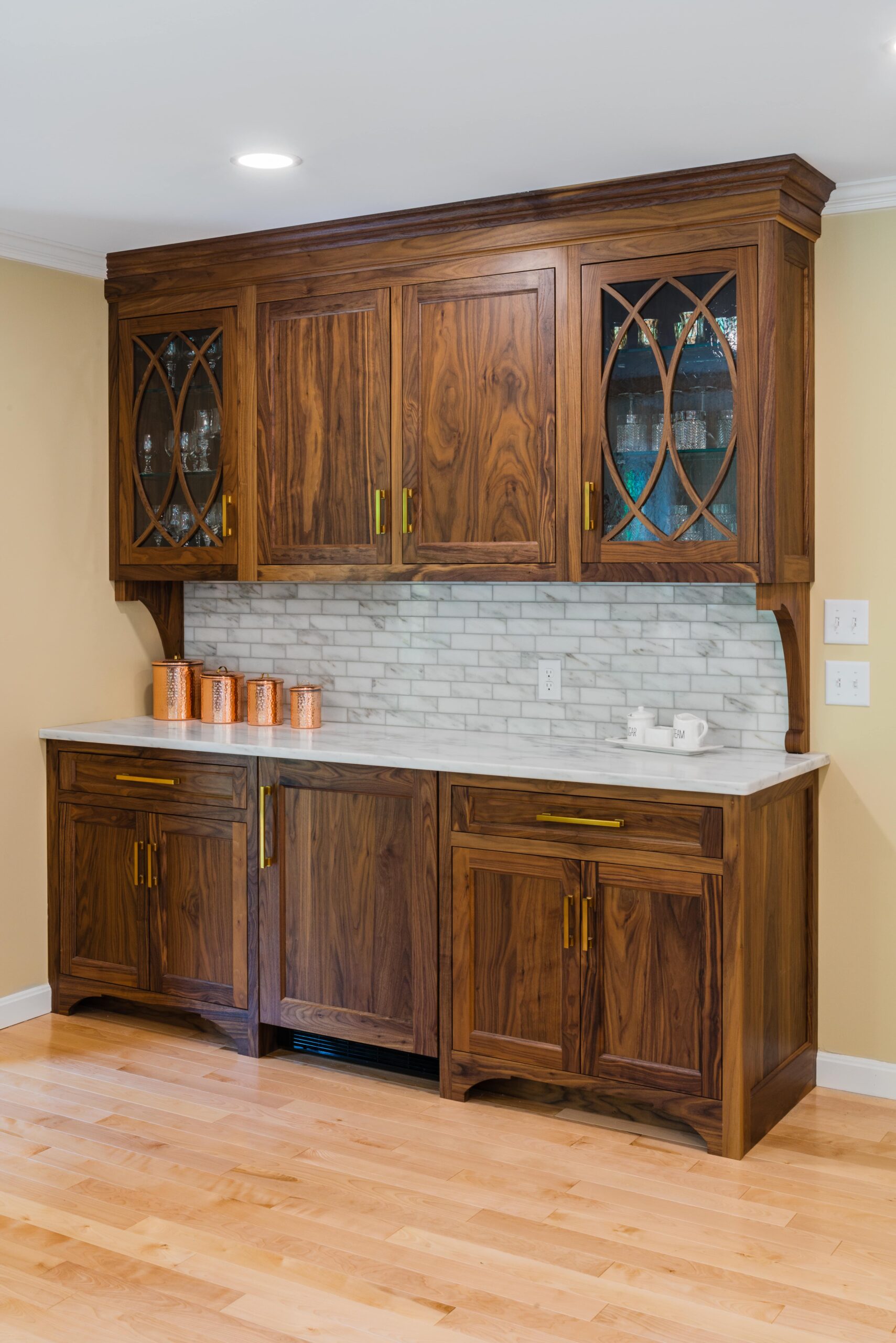 a kitchen with wooden cabinets and marble counter tops