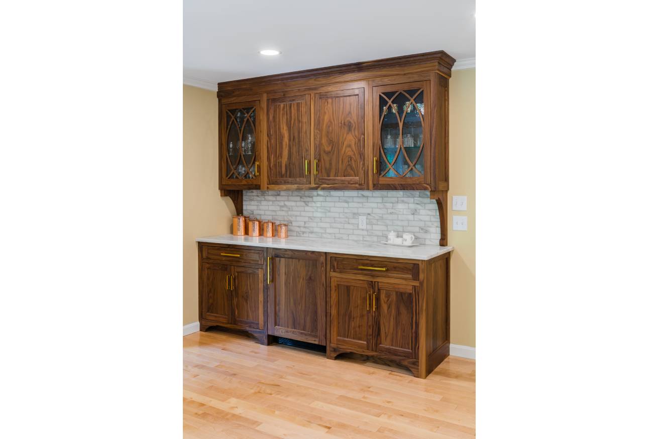 Brown cabinets and bar with tile backsplash