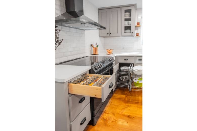 a kitchen with a stove and custom storage drawers