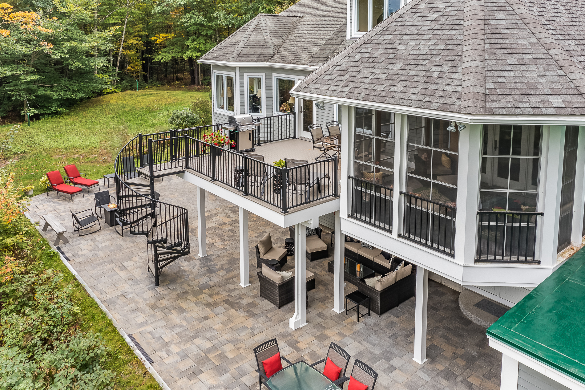 an aerial view of a house with patio and deck