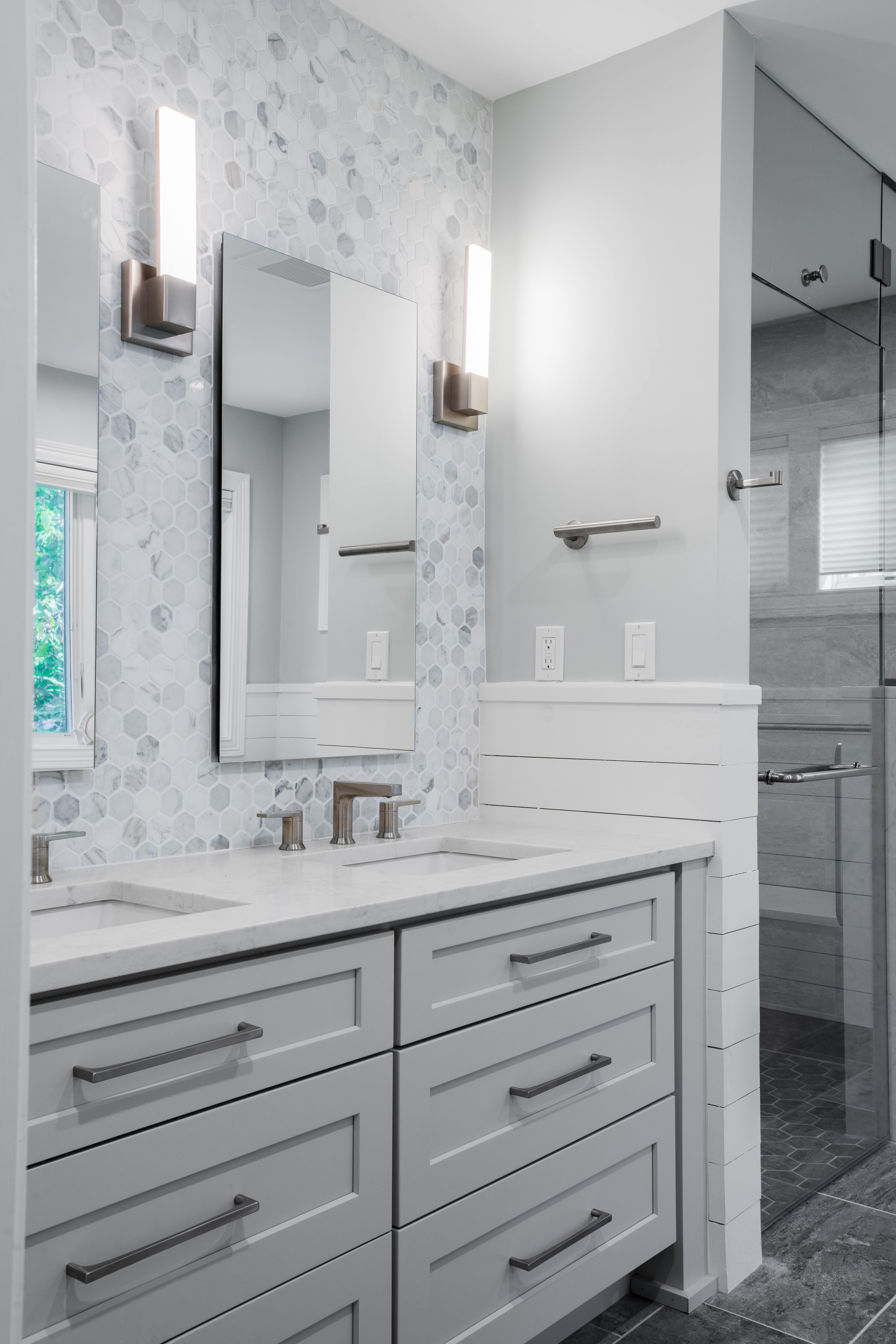 a gray bathroom with double vanity