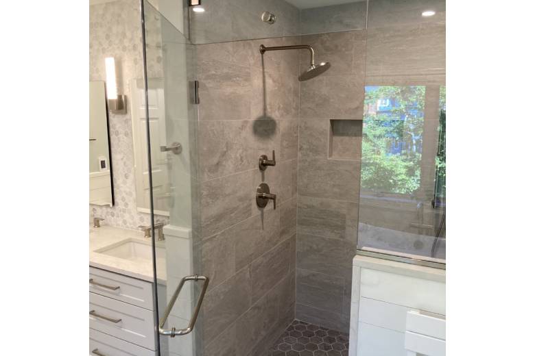 Walk-in shower with large natural tile and glass door