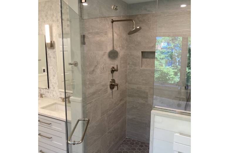 Walk-in shower with large natural tile and glass door