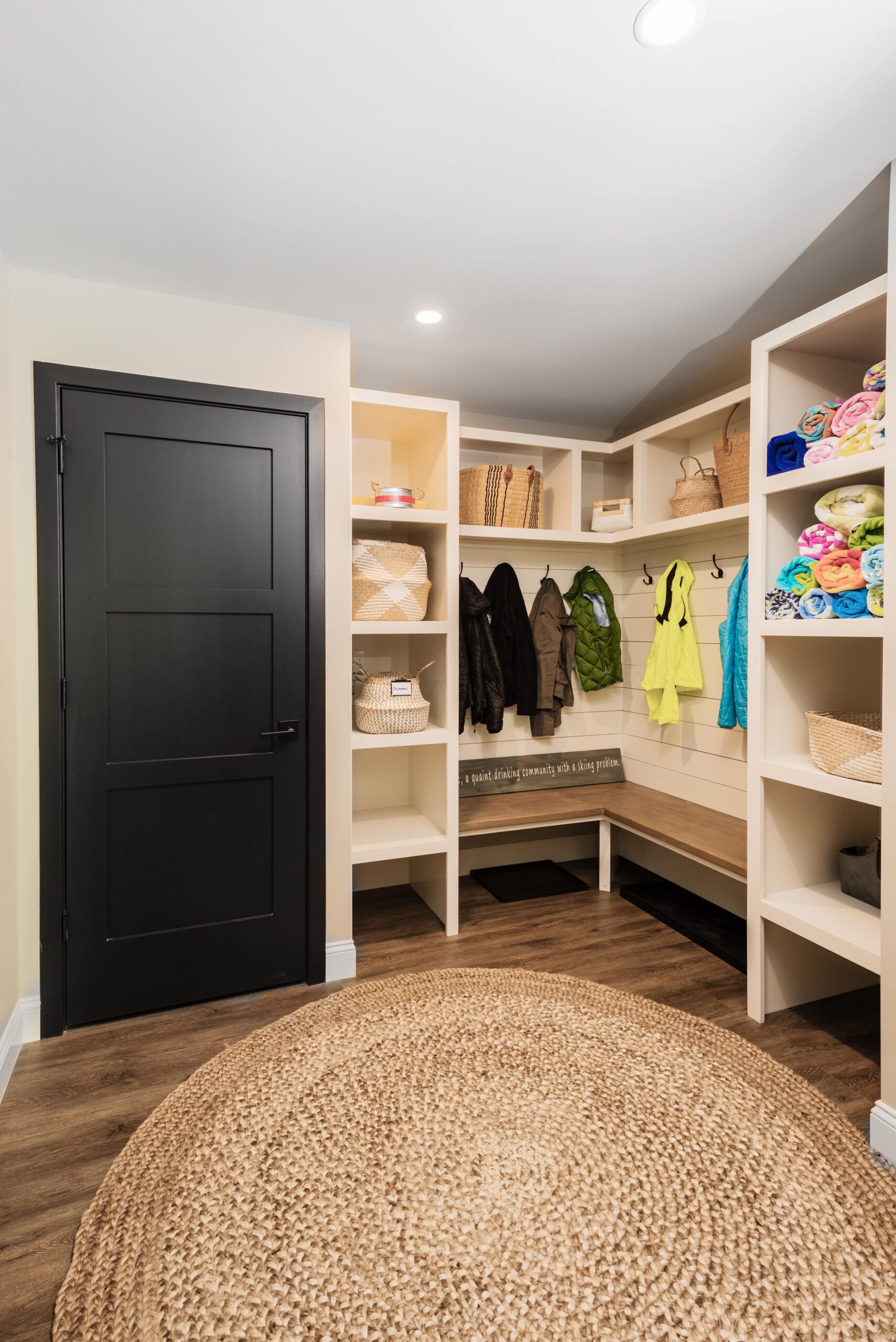 entryway with built-in storage and coat racks