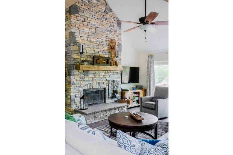 Living Room with a Brick Fireplace and a Wooden Coffee Table