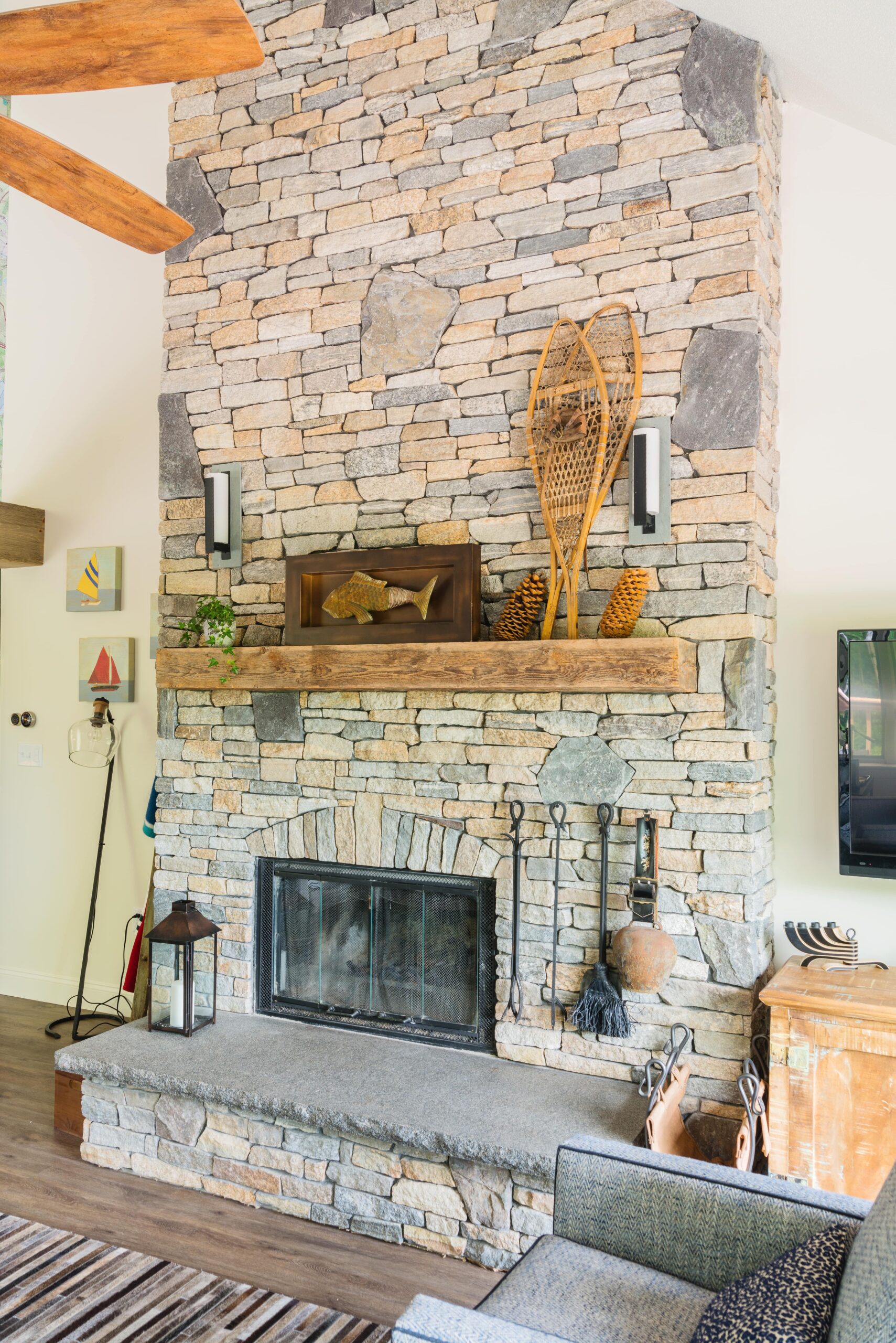 Large fireplace with stone wall and wood mantle