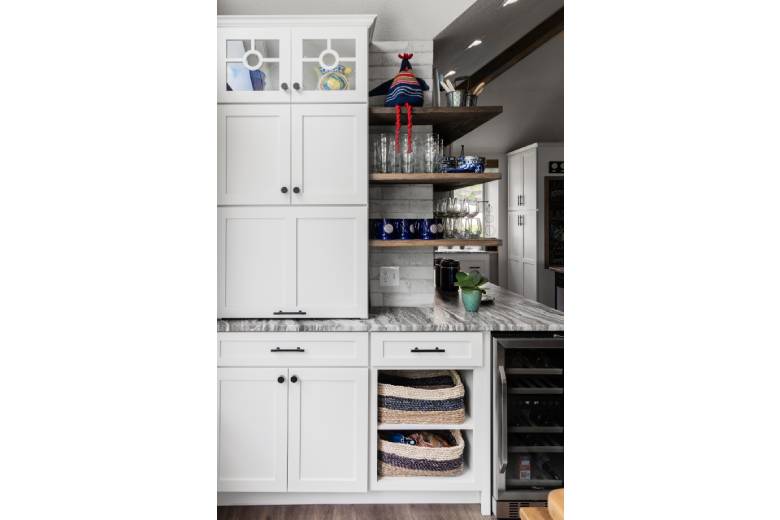 Granite Kitchen Counters with White Cabinets and a Wine Fridge