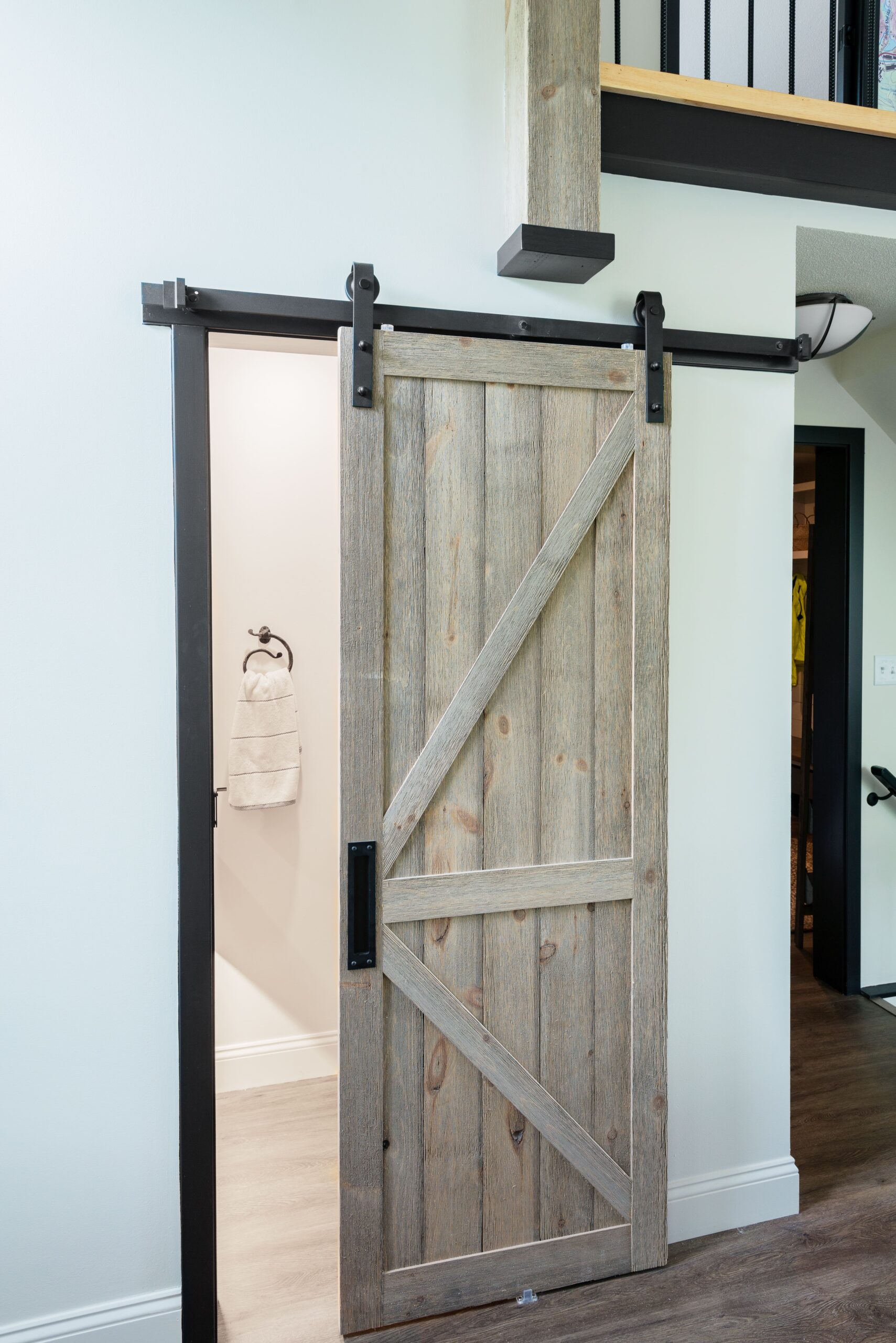 Sliding barn door with light grain natural wood