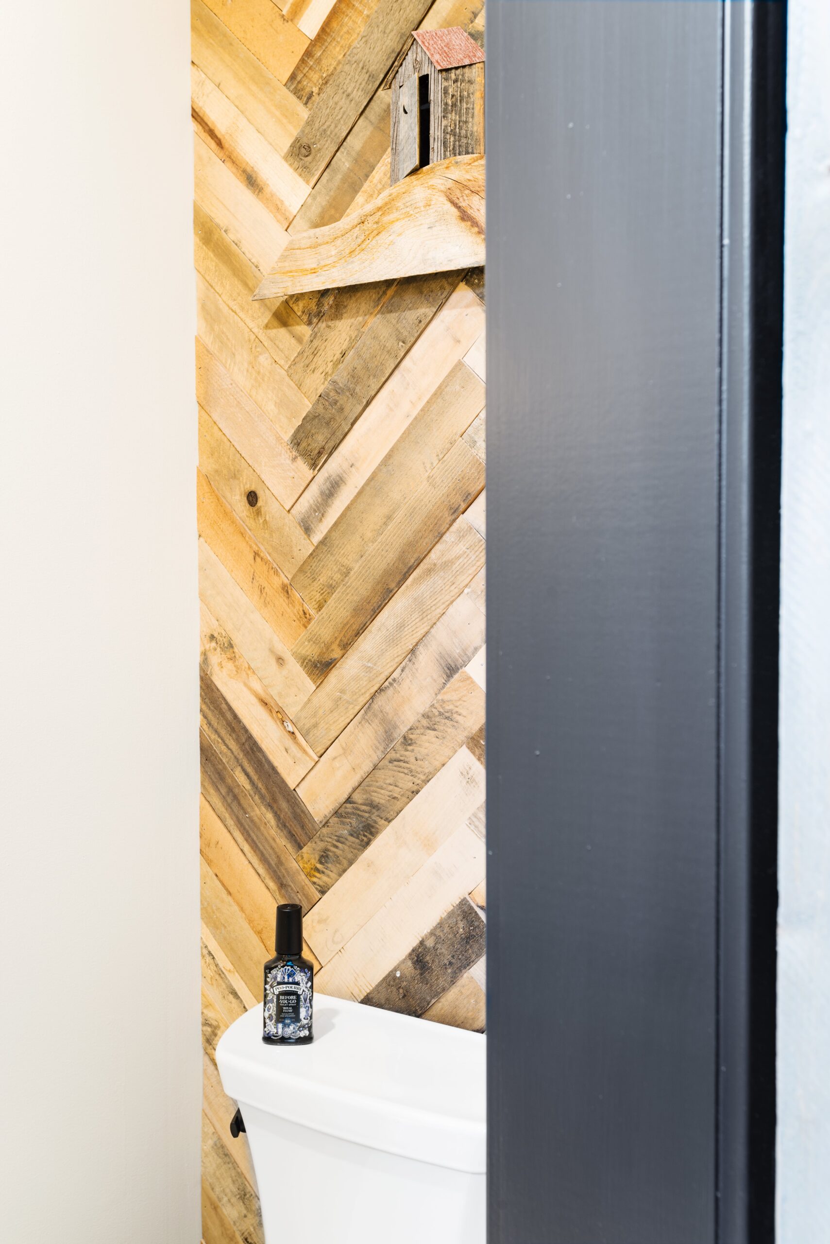 chevron wood paneling behind toilet