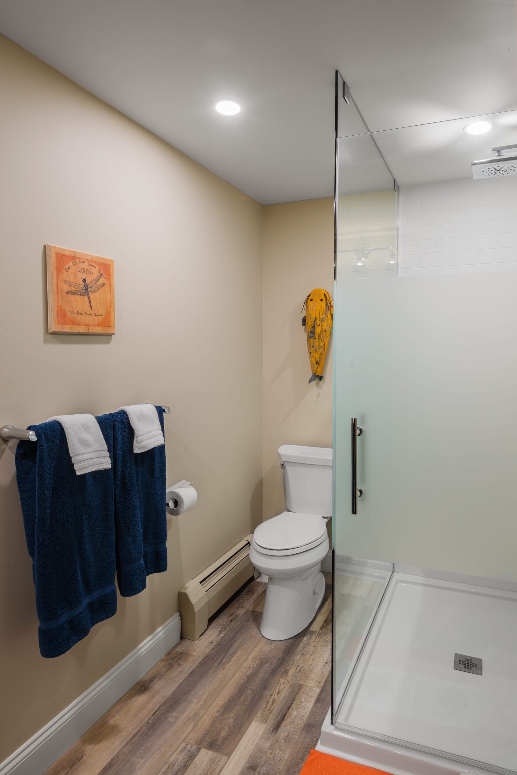 modern bathroom with a toilet, shower and towel rack