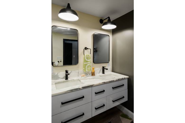Modern bathroom with black fixtures and white vanity