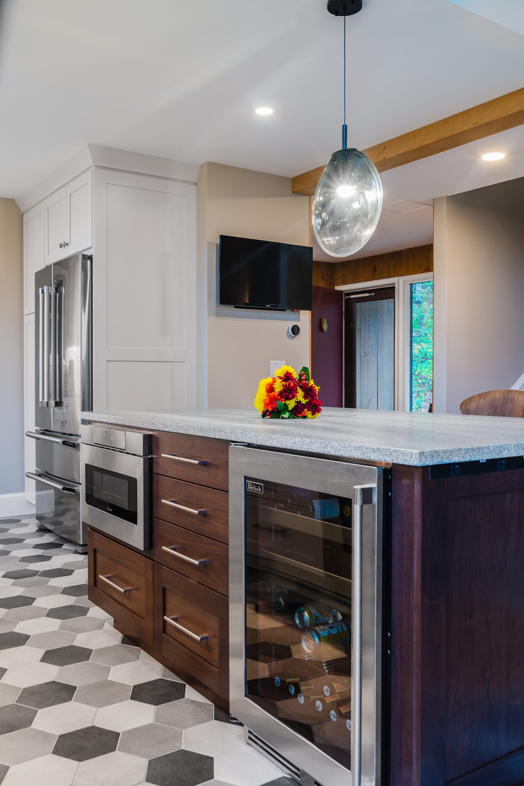 Modern kitchen remodel with dark island and grey honeycomb tile floor