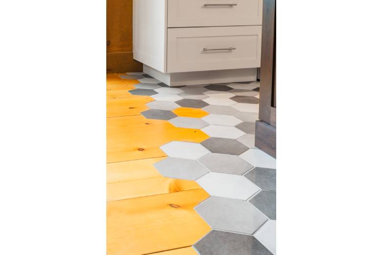 honeycomb tile floor transitioning into wood floor