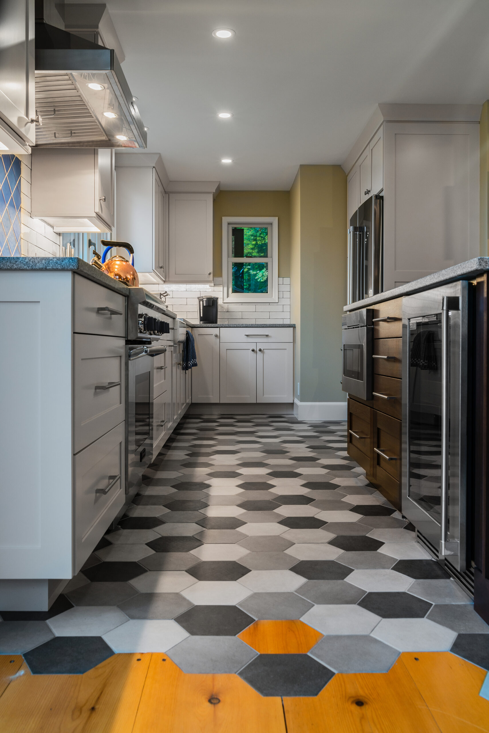 a kitchen with a honeycomb floor and white cabinets