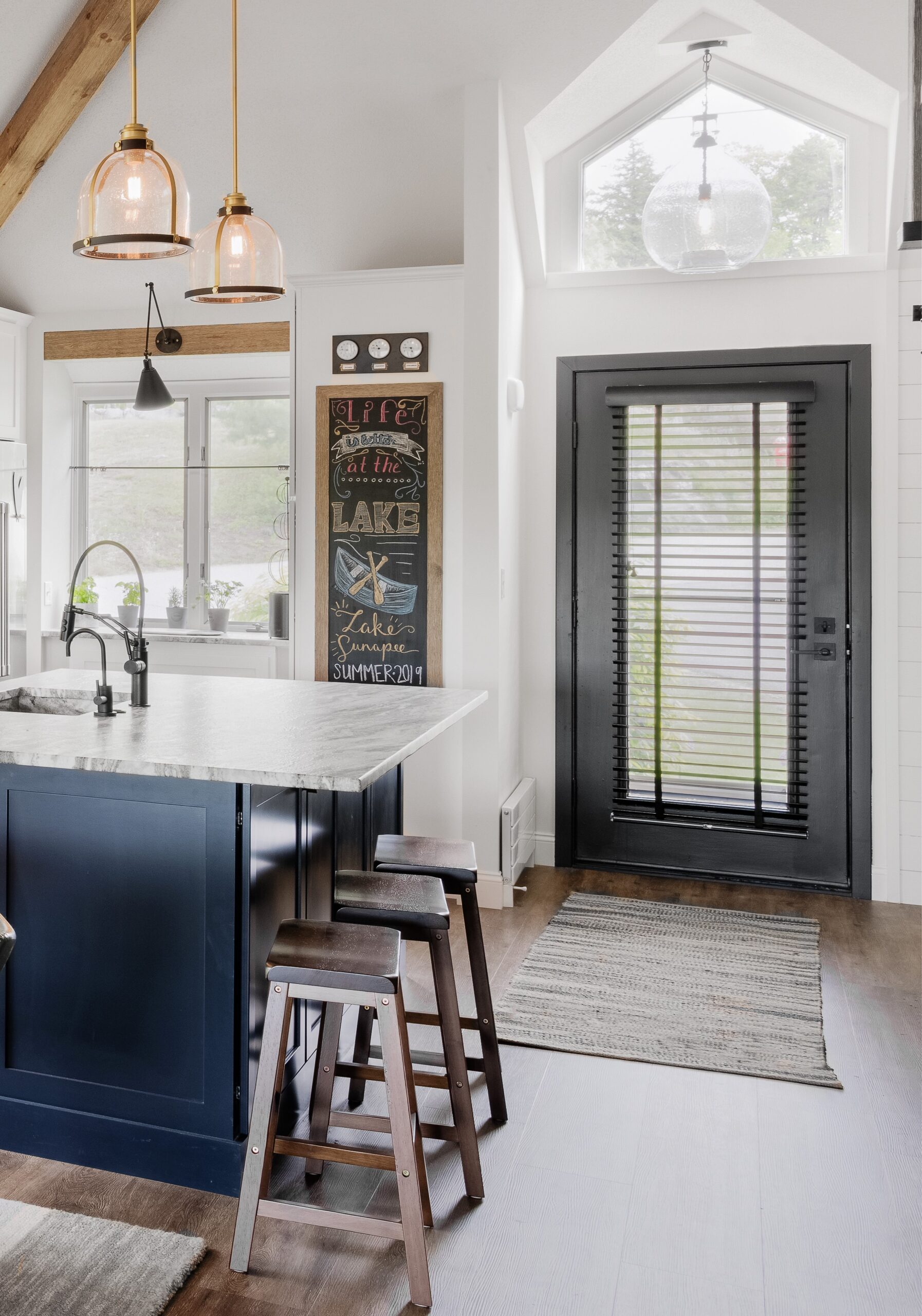 Interior view of exterior glass door. Black door with blinds pulled down over full-length glass pane.