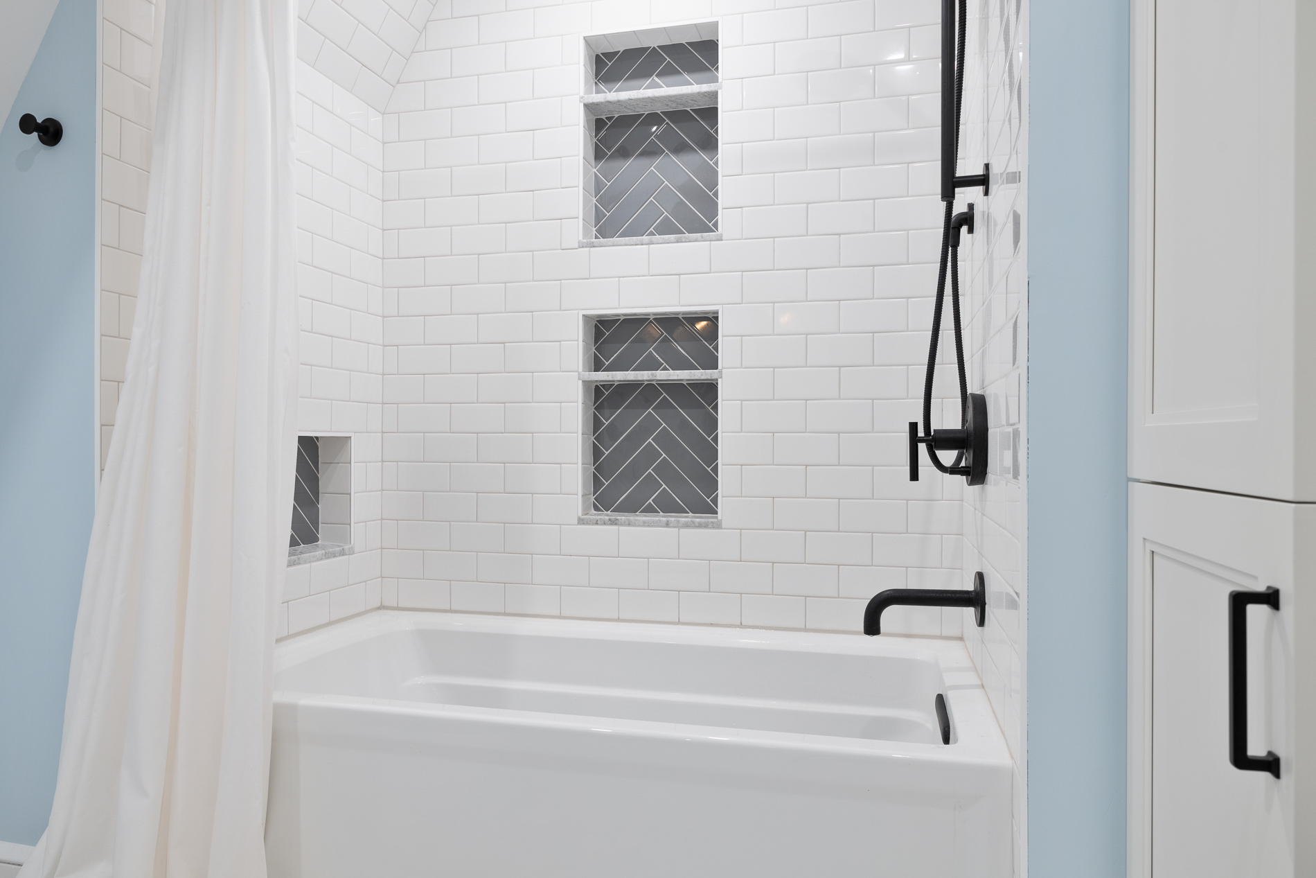 Bathroom Shower with White and Gray Subway Tile Backsplash