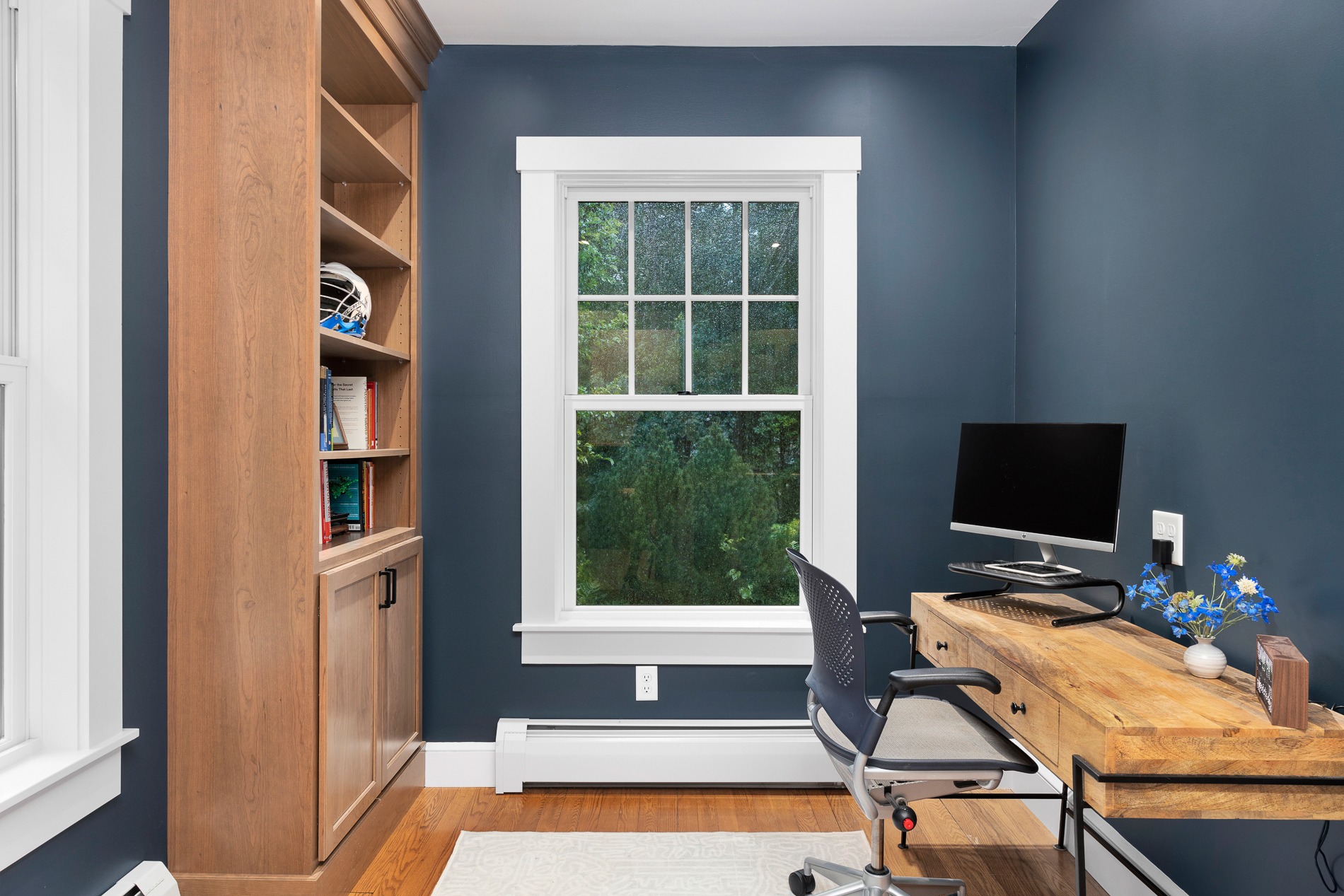 Modern Office Room in House with a Wooden Desk and Wooden Bookshelf Cabinet