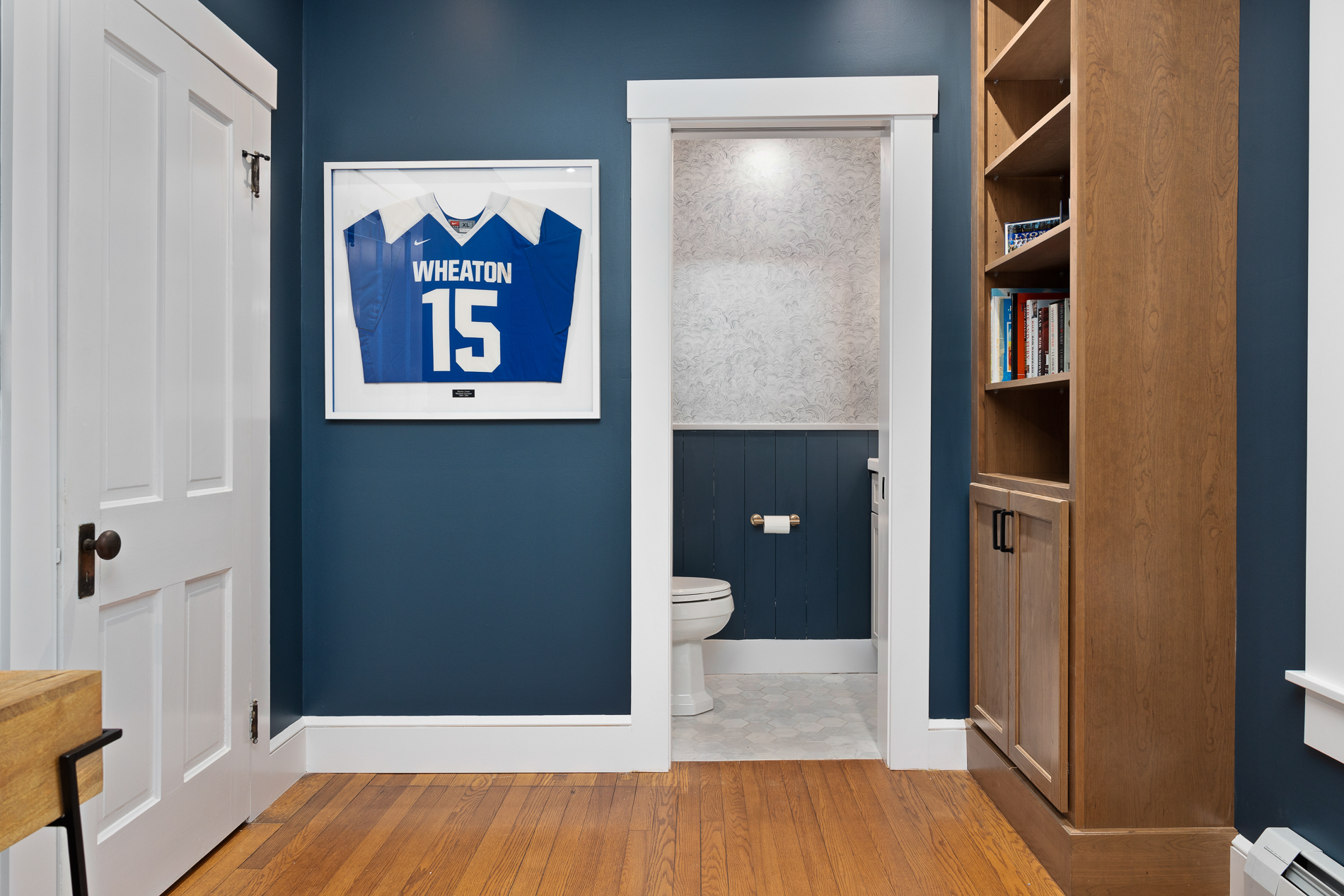 Bathroom Entry Way with Wooden Bookshelf and Wooden Floors