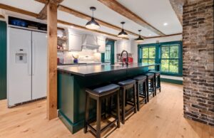 Kitchen remodel with dark cabinets and hardwood floors by Foremost Builders in Hanover, NH